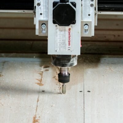 Precision CNC milling machine in action cutting wood for carpentry and industrial use.