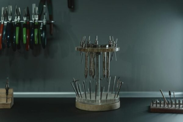 Tools arranged in a jewelry workshop, showcasing organized craftsmanship and precision.